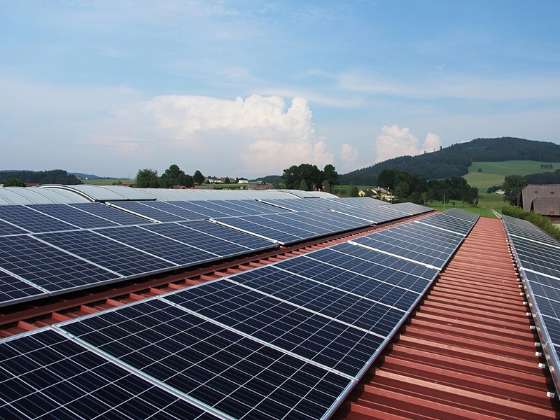 A large solar panel sitting on top of a roof.