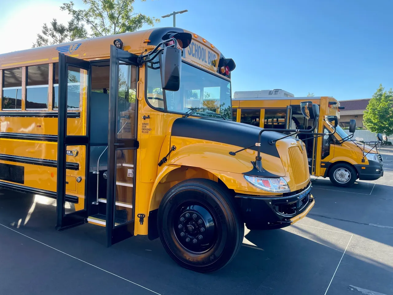 A yellow electric school bus parked in the parking lot.
