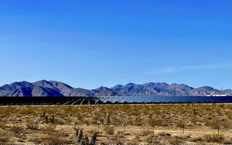Solar panels in desert mountainscape.