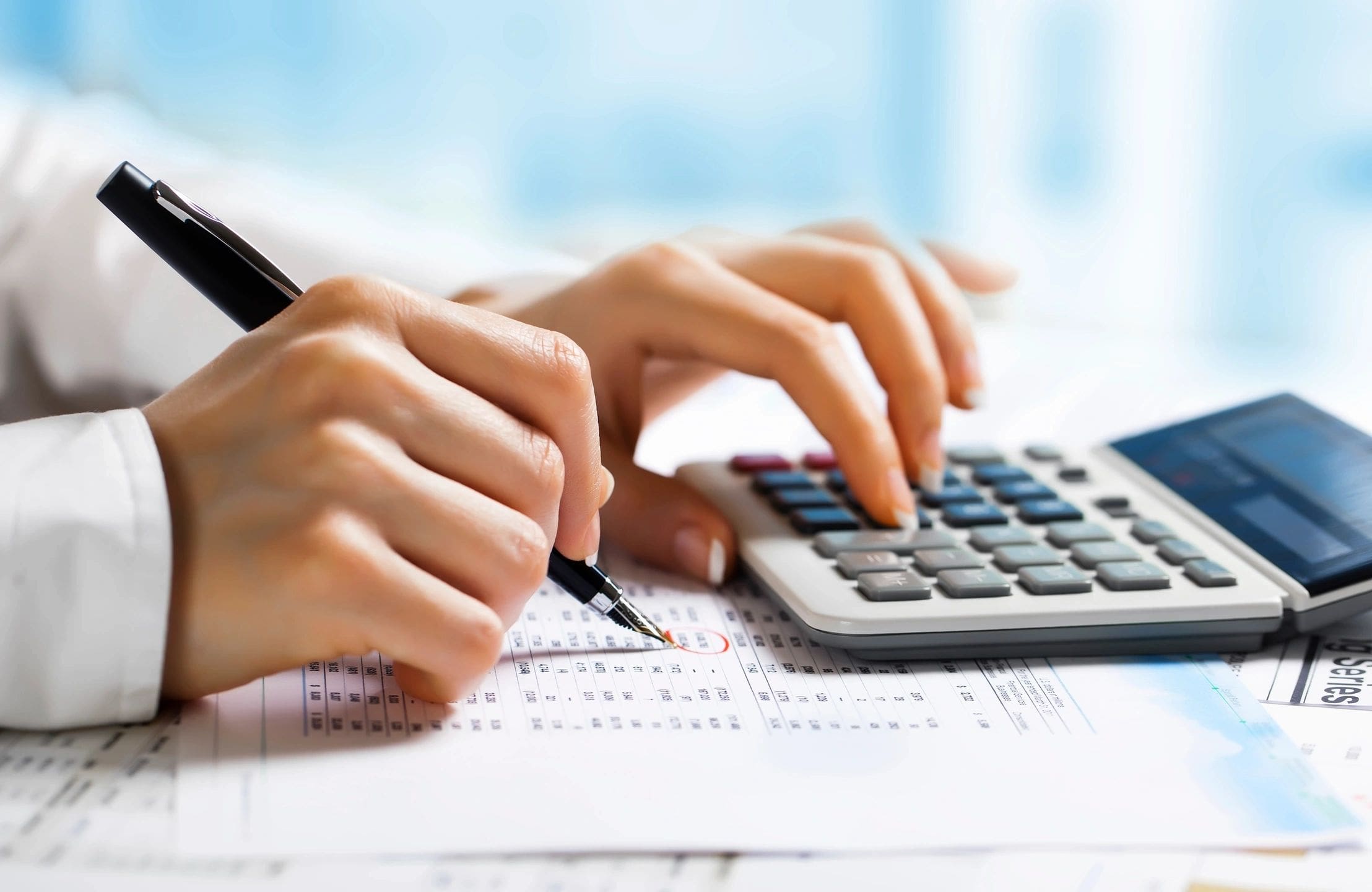 An employee doing financial analysis with a calculator.