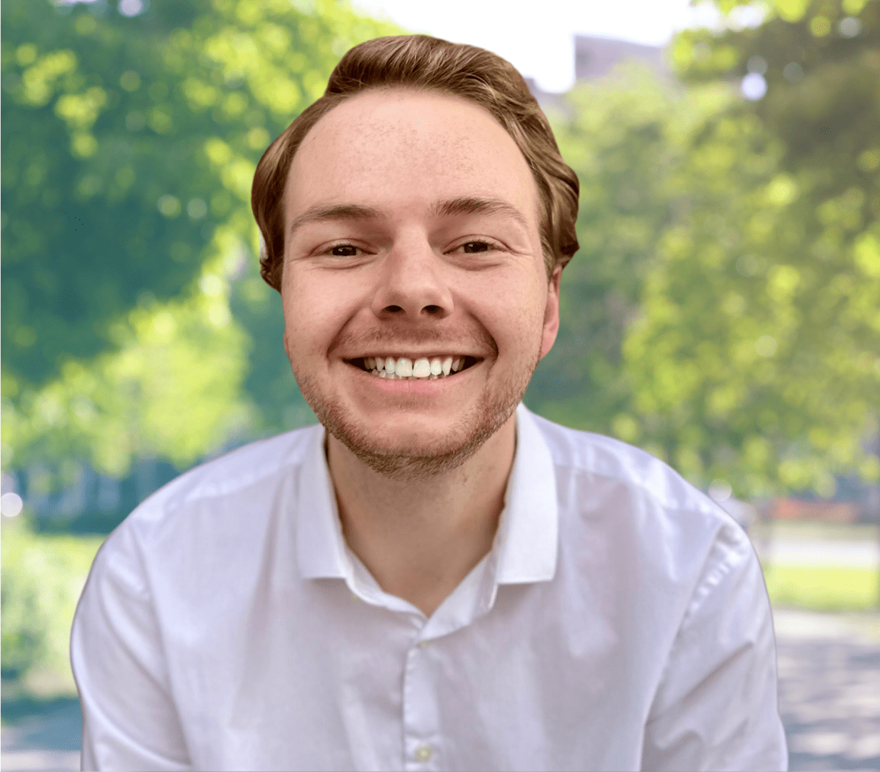 Smiling man in white shirt, outdoor.