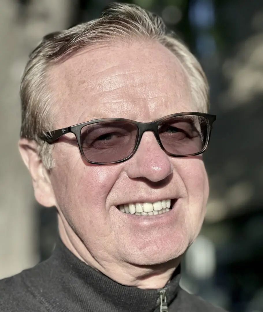 Smiling senior man wearing sunglasses.